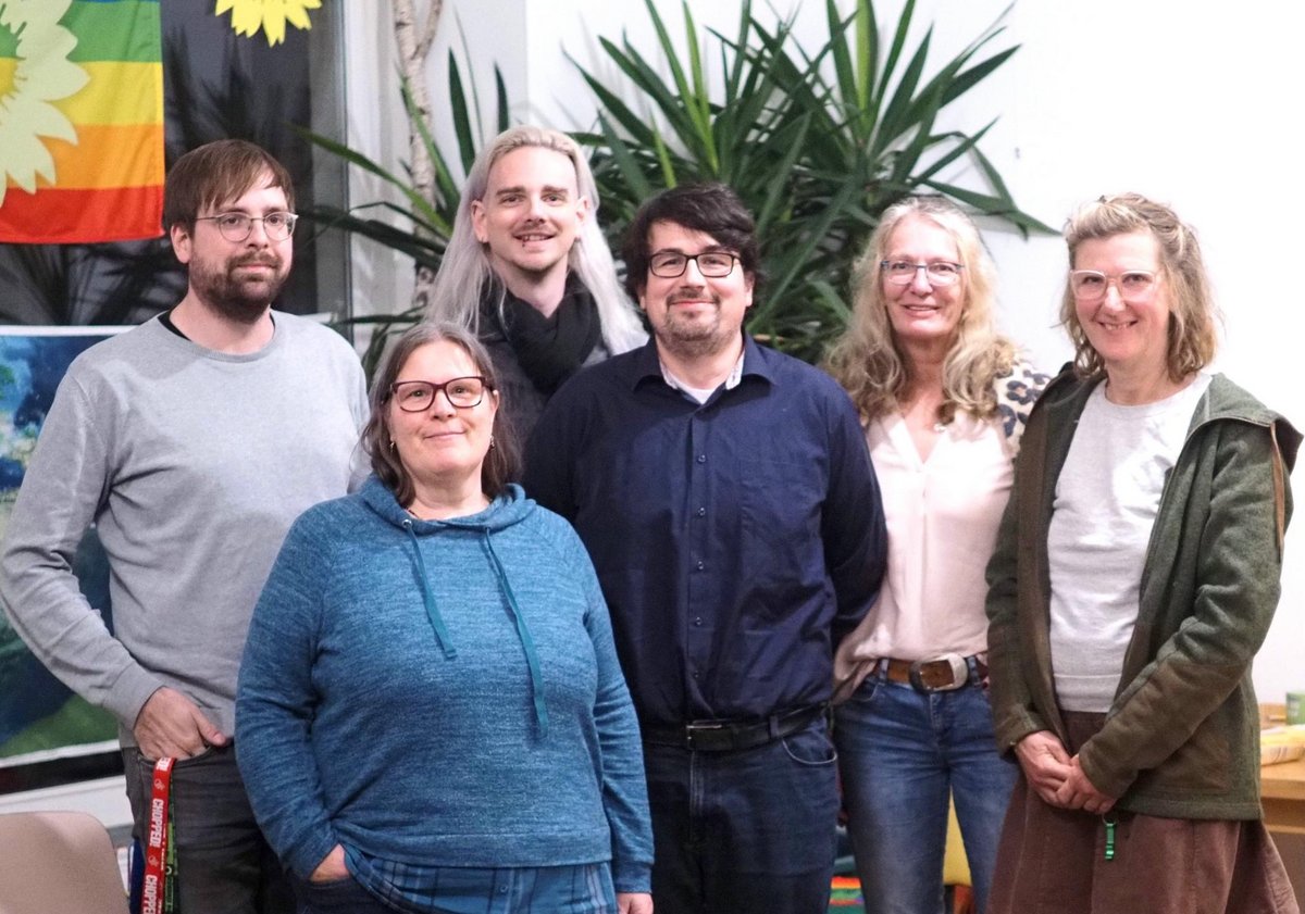 Vorstand der Grünen Prignitz: 6 Leute stehen vor einer Pflanze.